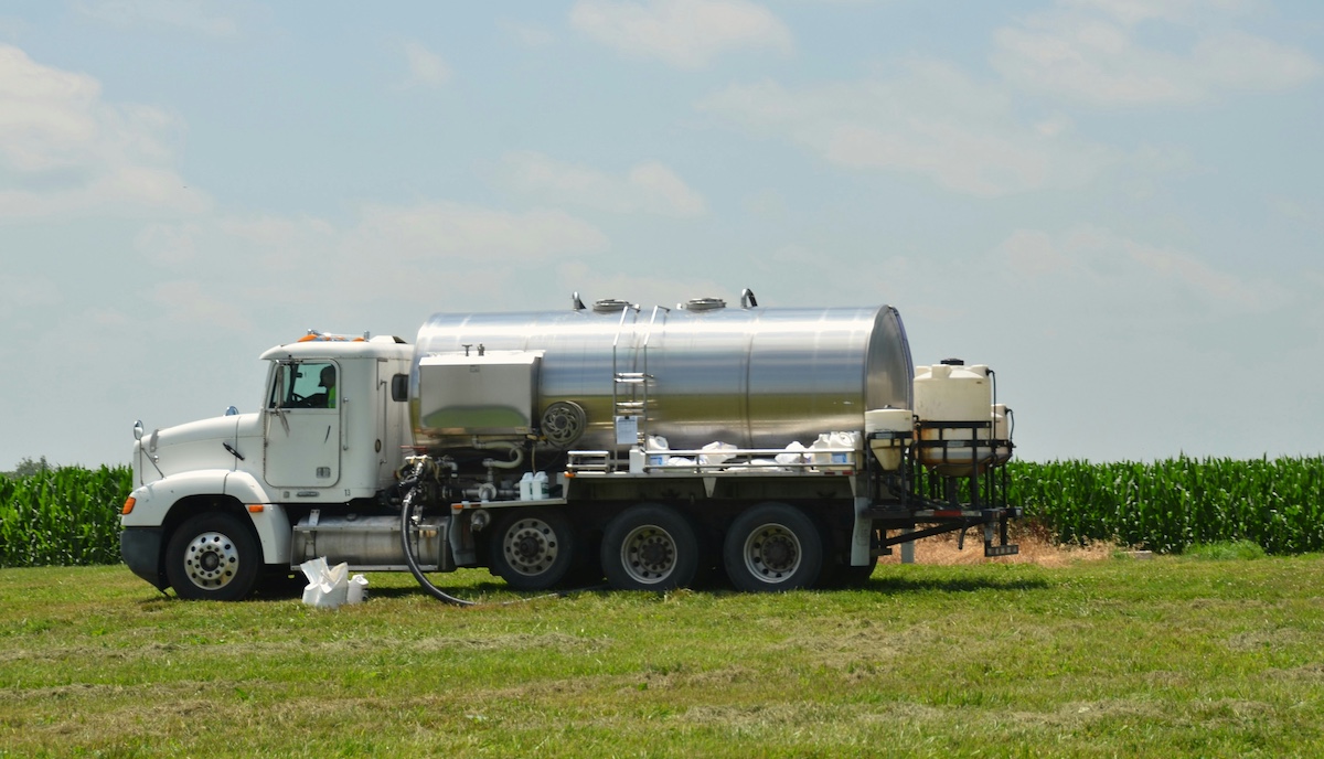 Septic service truck arriving at a mountain cabin driveway